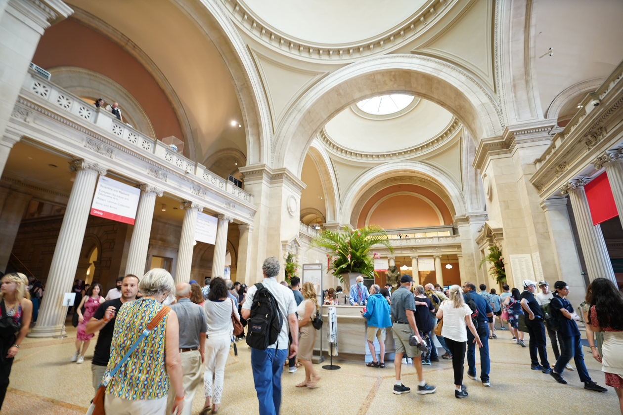 Visitors walk around the lobby of the Met Museum