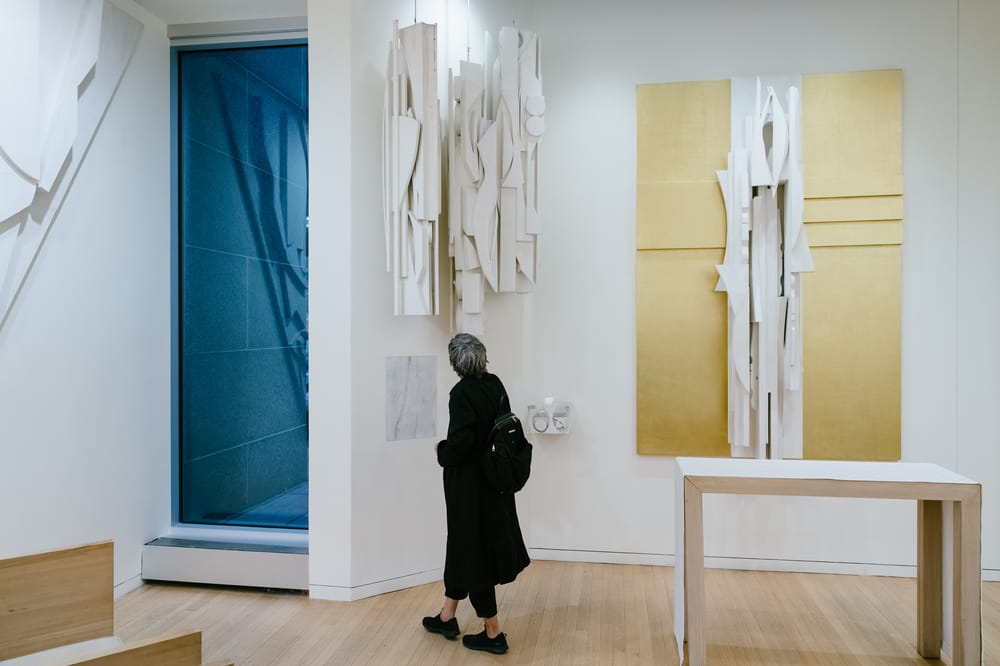 A woman looks a art hanging in Nevelson Chapel at Saint Peter's Church