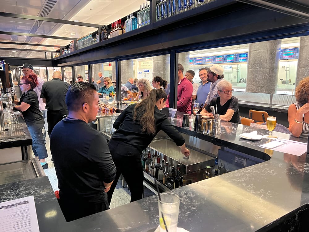 Bartenders prepare drinks at Tracks Raw Bar and Grill at Grand Central Madison