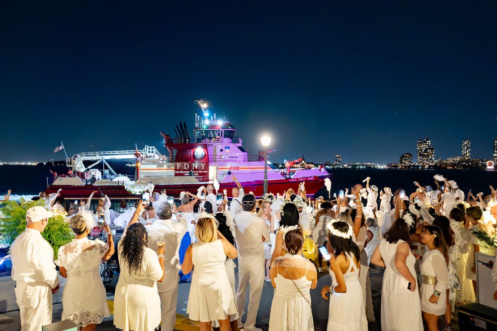 Diner en Blanc Guests wave to a fireboat