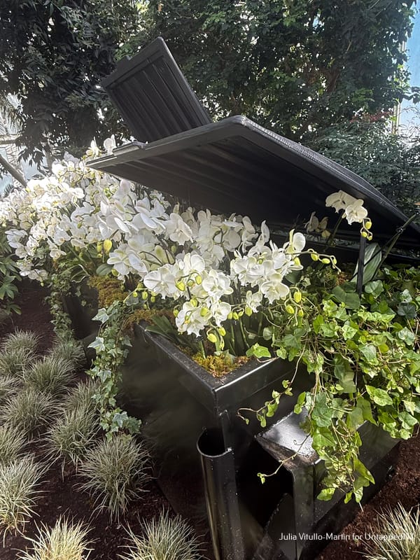 A dumpster filled with flowers at the NYBG Orchid Show