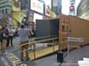 Gold Shipping Container in NYC’s Times Square is a Portal that Connects Americans to Others Around the World