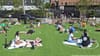 People on grass at Social distancing circles at Domino Park