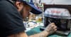 Daniel Cortes painting a miniature version of CBGB