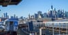 A train against the NYC skyline